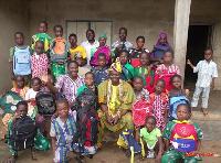 KIDS POSE WITH THEIR BACK TO SCHOOL PACK IN OUR THIRD CHILDREN BIBLE CLUB WITH COMMUNITY LEADER...